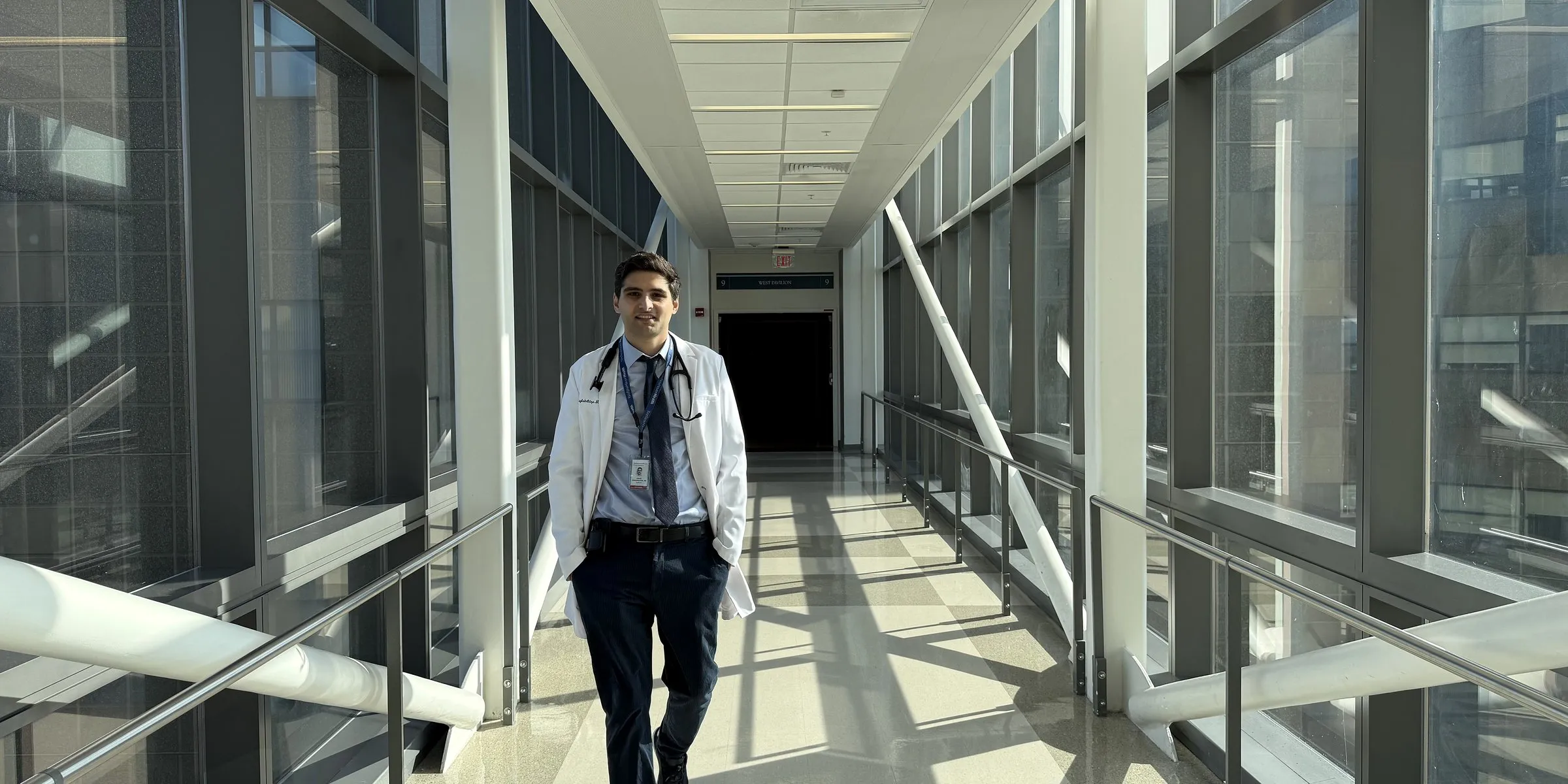 David Maglakelidze, MD, walking a sunlit hospital corridor at Yale New Haven Hospital